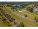 Drone shot of a green golf course with palm trees and sand traps at 134 Rotonda Cir, Rotonda West, FL 33947