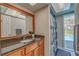 Bathroom with granite countertop, wood cabinets and shower at 134 Rotonda Cir, Rotonda West, FL 33947