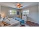 Bedroom with a queen-size bed, wood floors, and ceiling fan at 134 Rotonda Cir, Rotonda West, FL 33947