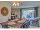 Dining area with wood table and chairs, pool view at 134 Rotonda Cir, Rotonda West, FL 33947