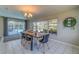 Dining room with pool view, wood table and modern chairs at 134 Rotonda Cir, Rotonda West, FL 33947