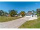 Light blue house with a white garage door and a nicely landscaped yard at 134 Rotonda Cir, Rotonda West, FL 33947