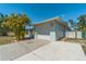 White garage door and long driveway at 134 Rotonda Cir, Rotonda West, FL 33947