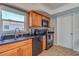 Kitchen with black appliances and wood cabinets at 134 Rotonda Cir, Rotonda West, FL 33947