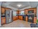 Modern kitchen with wood cabinets, granite counters and stainless steel appliances at 134 Rotonda Cir, Rotonda West, FL 33947