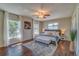 Main bedroom with a king-size bed, dark wood floors, and large windows at 134 Rotonda Cir, Rotonda West, FL 33947