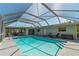 Spacious pool with covered patio and lounge chairs at 134 Rotonda Cir, Rotonda West, FL 33947