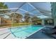 Relaxing screened pool area with lounge chairs at 134 Rotonda Cir, Rotonda West, FL 33947