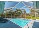 Inviting screened pool with lounge chairs and a lush backyard view at 134 Rotonda Cir, Rotonda West, FL 33947