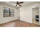 Bedroom showcasing hard wood floors, a ceiling fan, and a view from the large window at 14208 Woodhall Pl, Bradenton, FL 34202