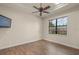 Bedroom featuring hardwood floors, a ceiling fan, and a large window at 14208 Woodhall Pl, Bradenton, FL 34202