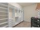 Walk-in closet with built in shelving and drawers at 14208 Woodhall Pl, Bradenton, FL 34202