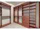 A large walk-in closet with custom shelving and drawers at 14208 Woodhall Pl, Bradenton, FL 34202