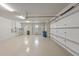 The garage is spacious and clean, with bright lighting and built-in shelving at 14208 Woodhall Pl, Bradenton, FL 34202