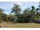 Backyard landscape with mature trees and vegetation at 15079 Wichita Rd, Port Charlotte, FL 33981