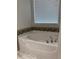 Bathroom with a bathtub, tile surround and updated fixtures at 15079 Wichita Rd, Port Charlotte, FL 33981