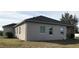 House exterior showcasing a side view with windows and a covered patio at 15079 Wichita Rd, Port Charlotte, FL 33981