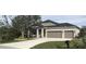 Single-story home with two-car garage and landscaped yard at 15079 Wichita Rd, Port Charlotte, FL 33981