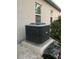 Efficient air conditioning unit sits on a concrete slab outside the home at 15079 Wichita Rd, Port Charlotte, FL 33981