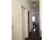 Bright hallway with dark hardwood floors and access to other rooms at 15079 Wichita Rd, Port Charlotte, FL 33981