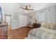 Comfortable bedroom with wood floors, ceiling fan, closet, and neutral color scheme at 1573 Shadow Ridge Cir, Sarasota, FL 34240