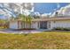 The exterior of this home is adorned with stone accents and a well landscaped yard at 1573 Shadow Ridge Cir, Sarasota, FL 34240