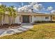 This home features decorative stone accents, mature landscaping, and a double door entrance at 1573 Shadow Ridge Cir, Sarasota, FL 34240