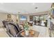 This living room includes tile floors, fireplace, and sliding door access to screened patio at 1573 Shadow Ridge Cir, Sarasota, FL 34240