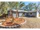 Newly painted house with a circular garden bed and palm trees at 2037 Linwood Way, Sarasota, FL 34232