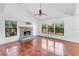 Spacious living room featuring hardwood floors and a stone fireplace at 2037 Linwood Way, Sarasota, FL 34232