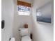 Small bathroom with toilet and decorative wall art at 207 Santarem Cir, Punta Gorda, FL 33983