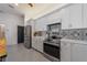 Modern kitchen with stainless steel appliances and white shaker cabinets at 207 Santarem Cir, Punta Gorda, FL 33983