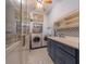 Bright laundry room, featuring washer, dryer and ample storage at 207 Santarem Cir, Punta Gorda, FL 33983