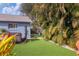 Artificial turf backyard with cornhole and hot tub at 2207 22Nd W St, Bradenton, FL 34205