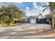 Single-Gathering home with a blue facade, white garage door, and a landscaped yard at 2207 22Nd W St, Bradenton, FL 34205