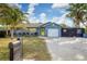 Cute bungalow with a yellow door, paver driveway, and fenced backyard at 2207 22Nd W St, Bradenton, FL 34205