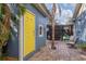 Charming backyard patio with yellow door and seating area at 2207 22Nd W St, Bradenton, FL 34205