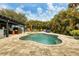 Freeform swimming pool with surrounding patio and tropical landscaping at 2207 22Nd W St, Bradenton, FL 34205