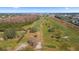 Aerial view of a golf course with trees and a road at 2459 Franciscan Dr # 5, Clearwater, FL 33763