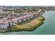 Aerial view of waterfront condo community with lush landscaping and boat access at 250 Santa Maria St # 120, Venice, FL 34285