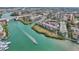 Aerial view of waterfront community with boat and lush landscape at 250 Santa Maria St # 120, Venice, FL 34285