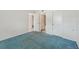 Spacious bedroom with blue carpet and access to a bathroom at 250 Santa Maria St # 120, Venice, FL 34285