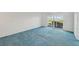 Bedroom with blue carpet and sliding glass doors to balcony at 250 Santa Maria St # 120, Venice, FL 34285