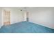 Bedroom with blue carpet, ceiling fan and ensuite bathroom at 250 Santa Maria St # 120, Venice, FL 34285