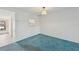 Bright dining room with light blue carpet and kitchen pass-through at 250 Santa Maria St # 120, Venice, FL 34285