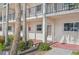 Condo building exterior with palm trees and walkway at 250 Santa Maria St # 120, Venice, FL 34285