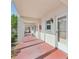 Covered walkway leading to condo units with red tile flooring at 250 Santa Maria St # 120, Venice, FL 34285