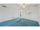 Living room with blue carpet and kitchen pass-through at 250 Santa Maria St # 120, Venice, FL 34285