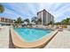 Community pool with lounge chairs and patio area, near condo building at 250 Santa Maria St # 120, Venice, FL 34285