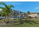 Spacious backyard, lush landscaping, and screened pool at 2551 Morrietta Ln, North Port, FL 34286